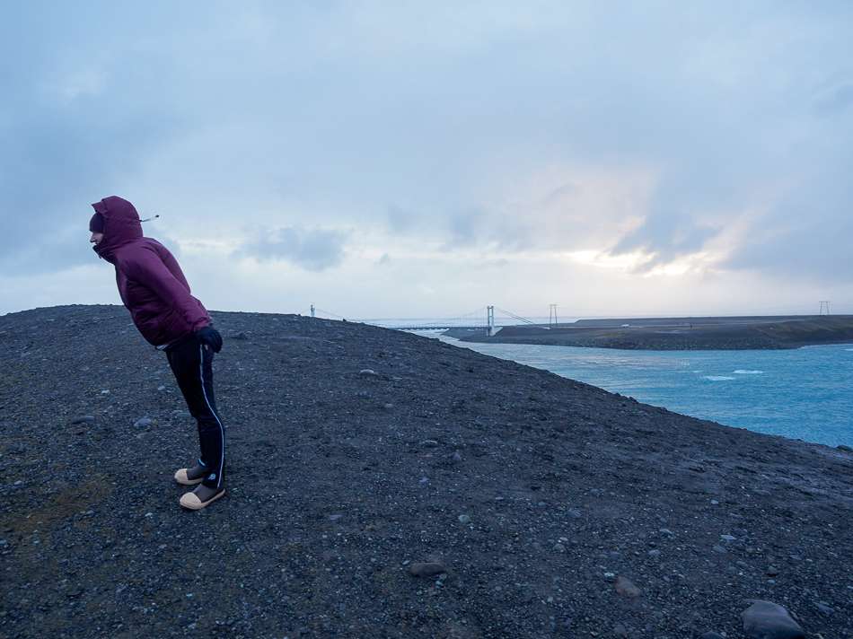 A woman standing against Iceland wind