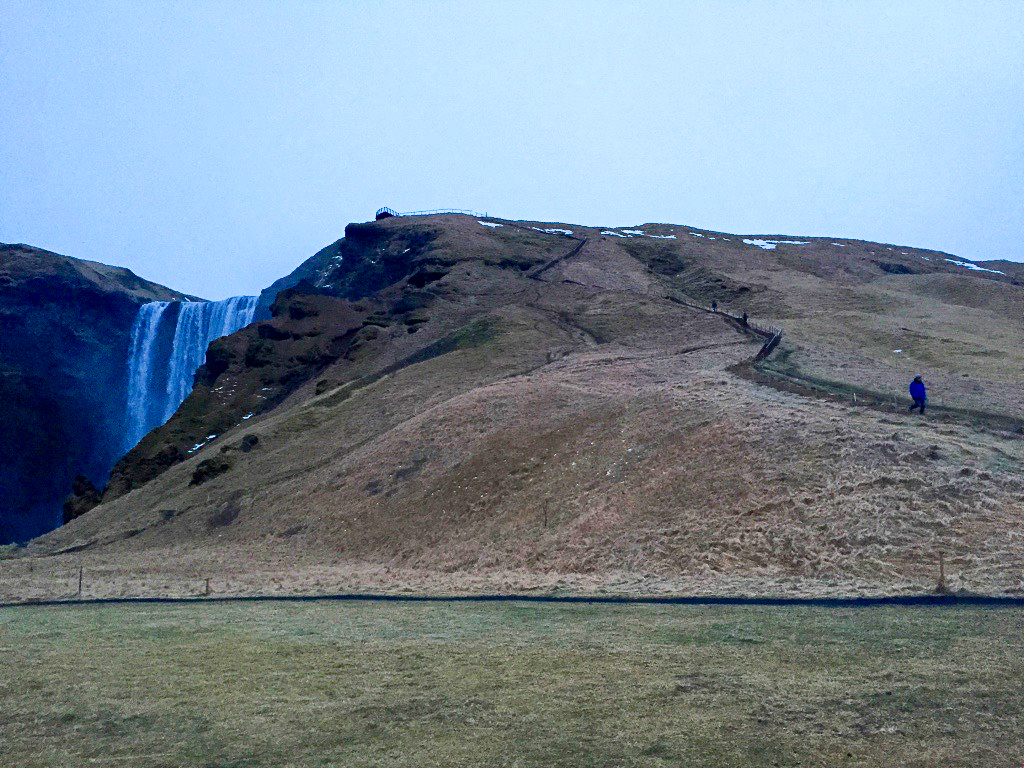 Skogafoss hiking up waterfall winter