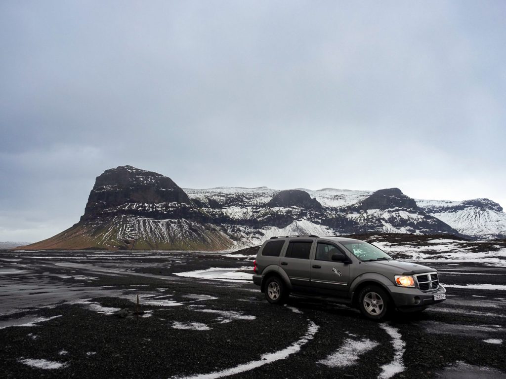 A gray campervan on an Iceland road
