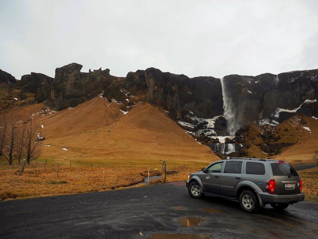 Harmafoss waterfall with a campervan in front Iceland Winter