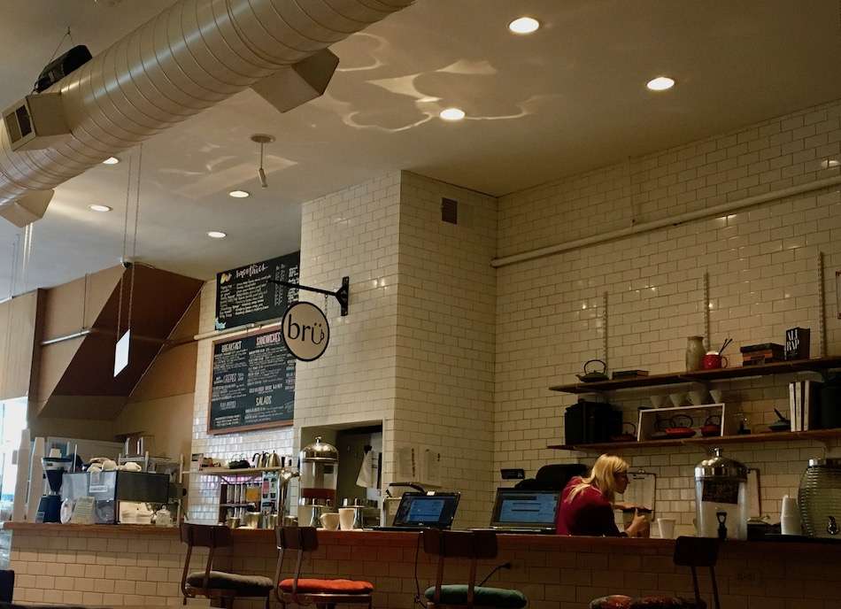 The white tiled walls and counter area of Brü Coffee in Chicago.