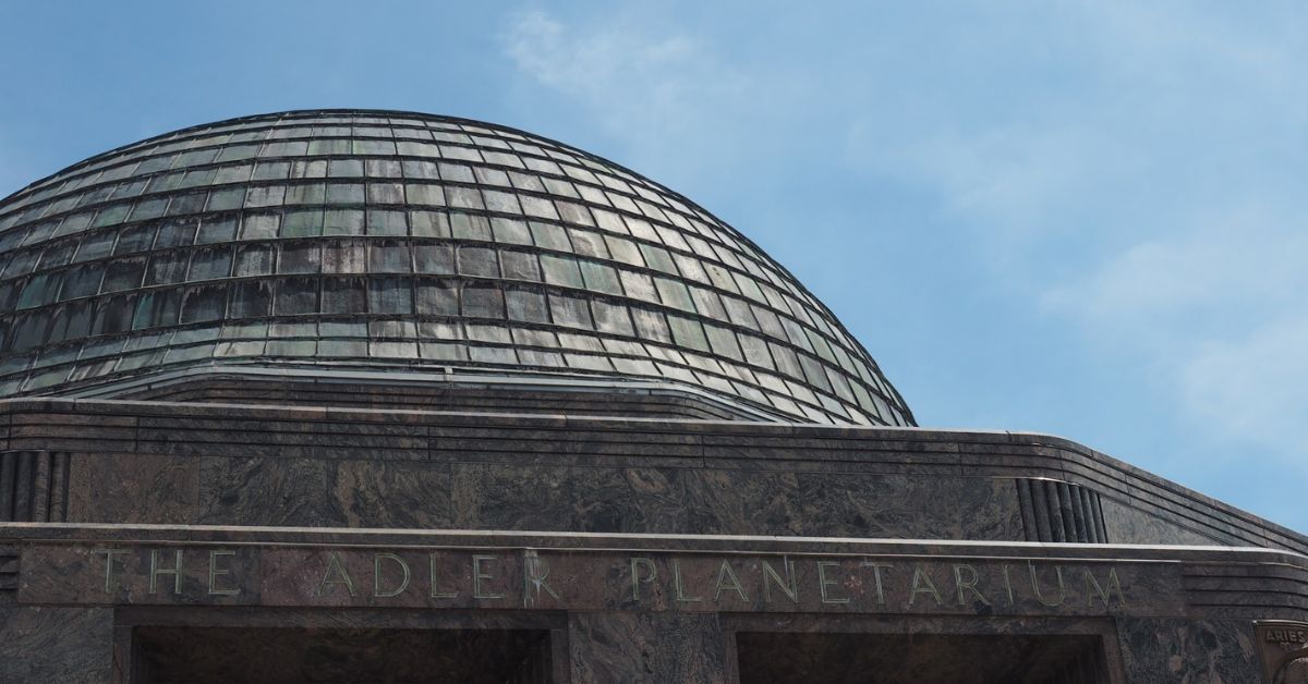 Blue sky behind the domed roof of the Adler Planetarium in Chicago.