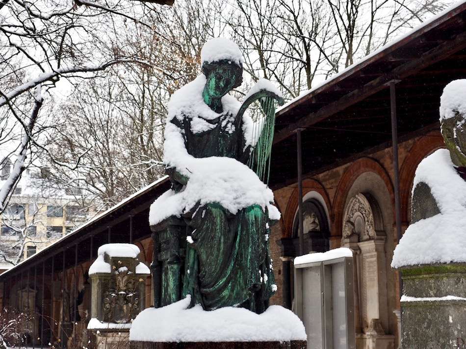 angel tomb stone covered in snow