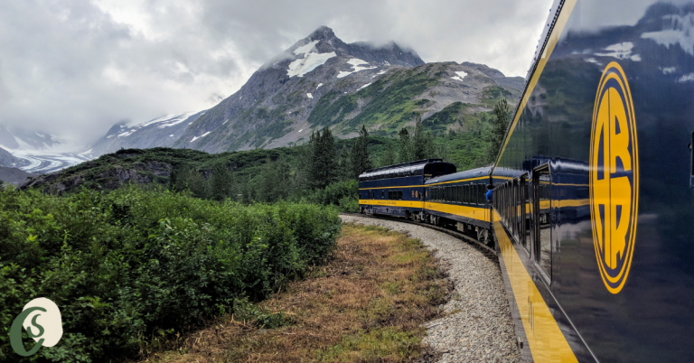 Alaska Railroad train approaching a glacier and mountains on the Glacier Discovery Train