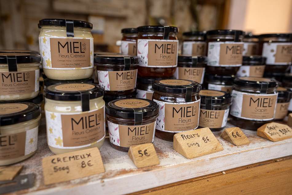 jars of local honey are lined up in an Alsace Christmas Market booth