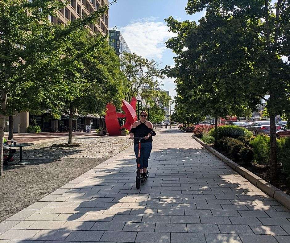 Pamela from Directionally Challenged Traveler Riding E-Scooter for sustainable travel