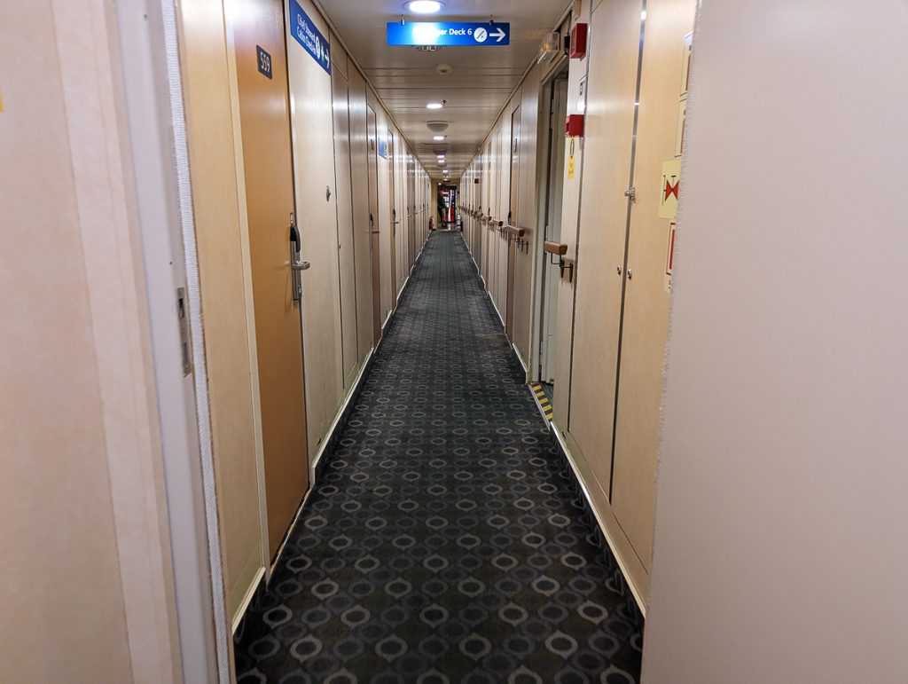 A narrow hallway with lots of doors on board a BC Ferry.