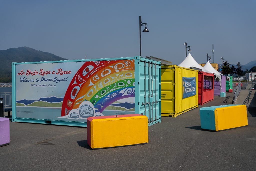 Brightly painted shipping containers with text saying "Welcome to Prince Rupert British Columbia, Canada."