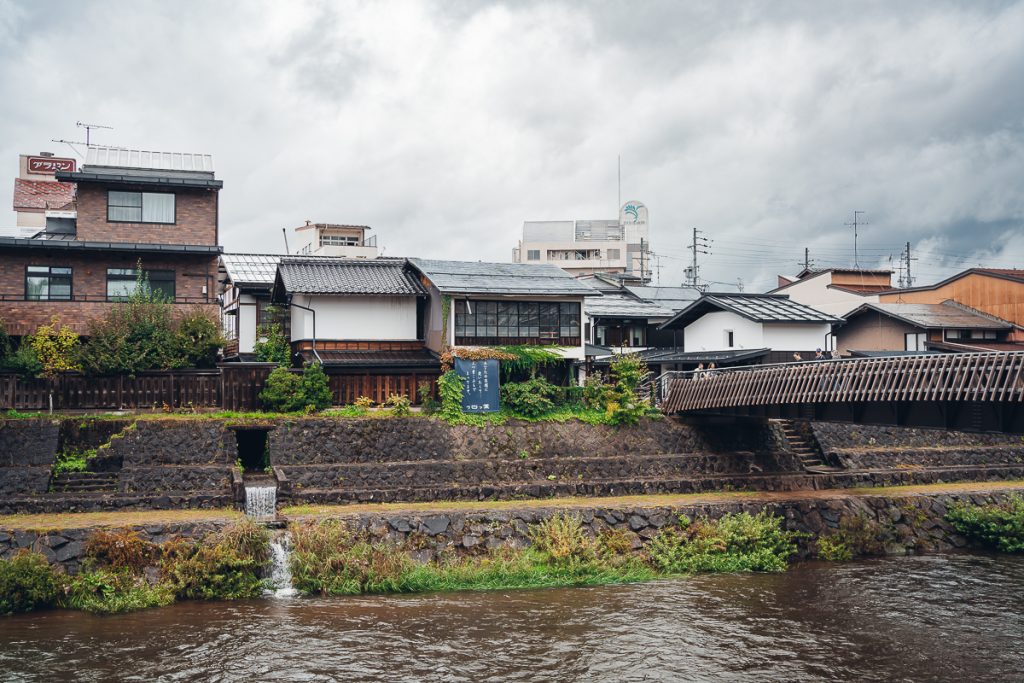 A view of the river, riverside buildings and a bridge in Takayama, Japan.