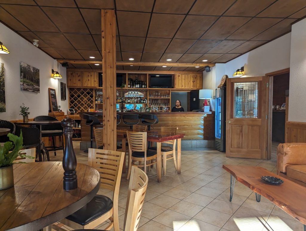 The bar at Haida House with lots of wooden furniture.