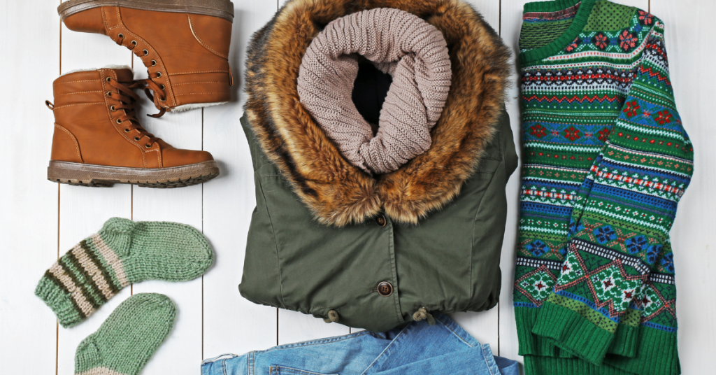 A collection of winter clothing laid out as an example of what to pack for a German Christmas market