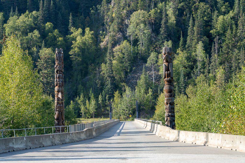 Nass Valley home of the Nisga'a Nation two clan totem poles over a bridge