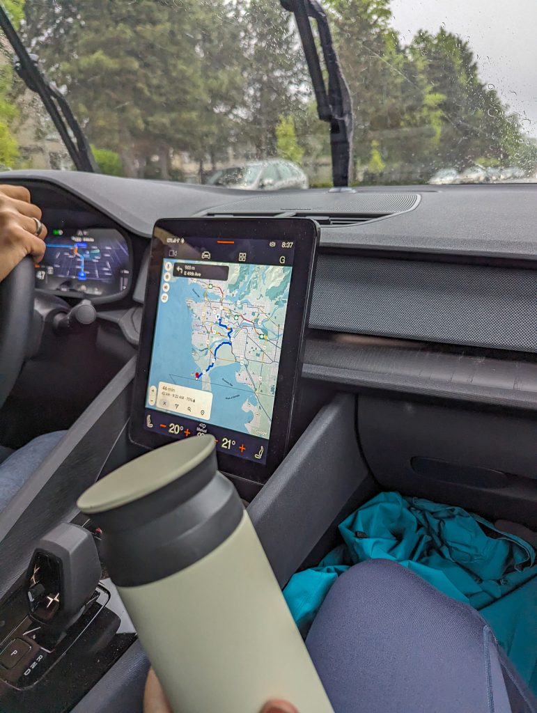 A computer screen mounted in a car showing a driving route on a map.