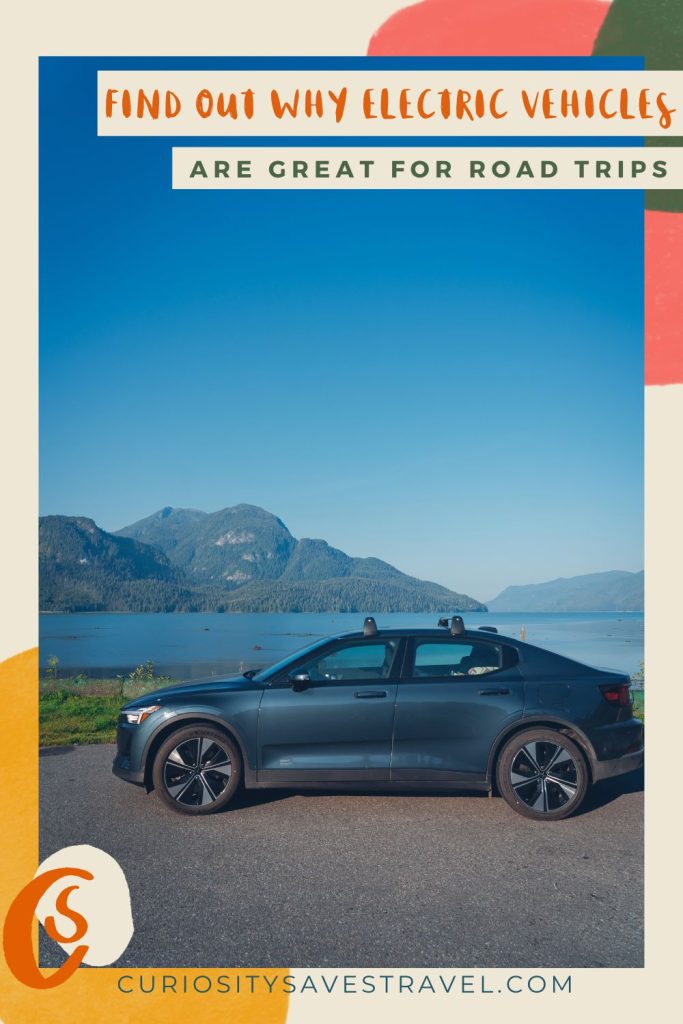 A portrait photo of a blue car parked next to a lake with mountains and blue sky in the background. At the top of the photo is text saying "Find out why electric vehicles are great for road trips." At the bottom is text saying curiositysavestravel.com