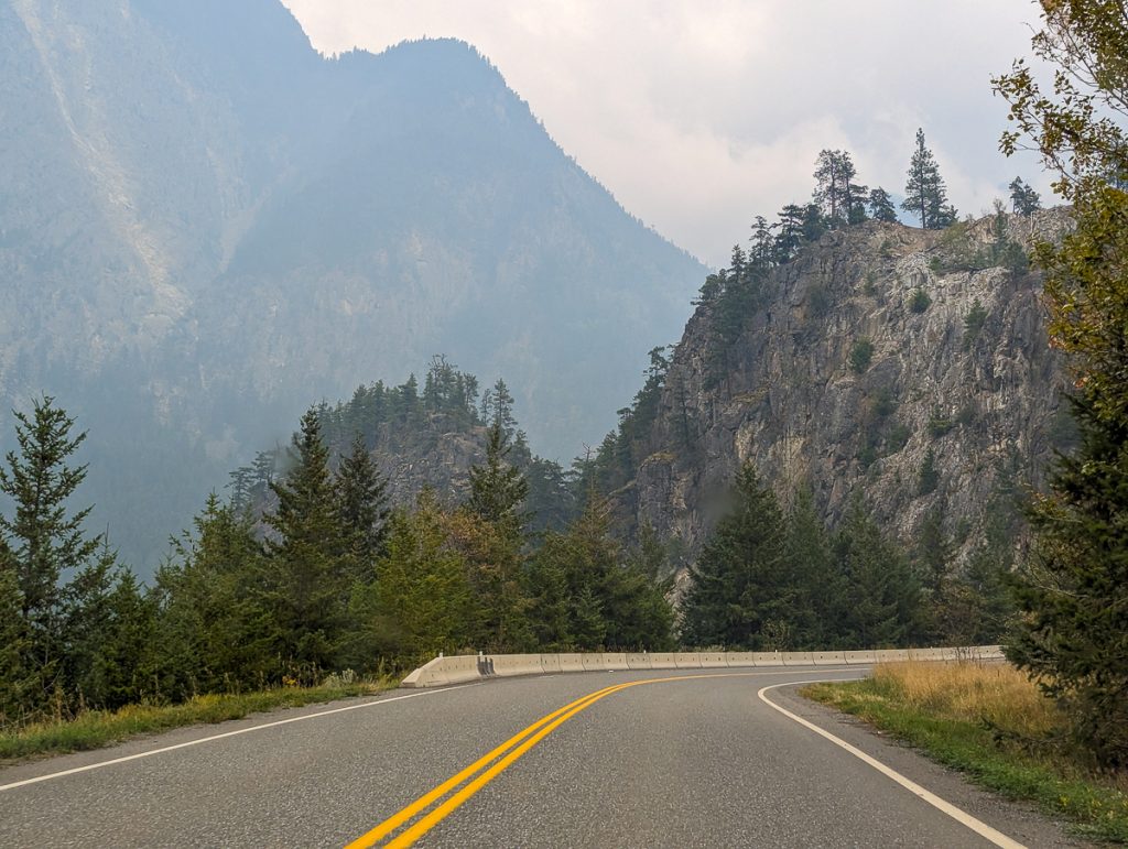 a winding mountain road during an EV road trip