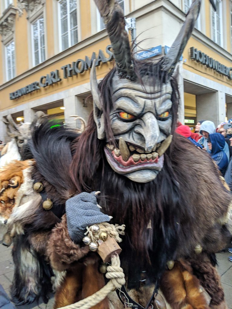 a demonic creature with horns in Krampus parade Munich