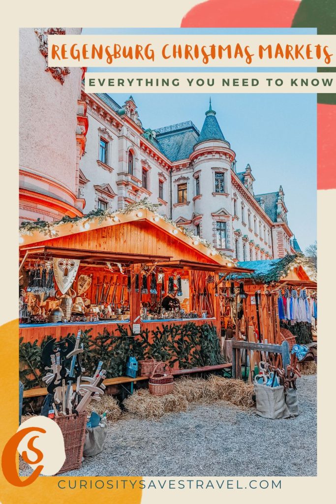 A photo of a wooden Christmas chalet stall selling wooden swords in front of a palace, with text above that reads "Regensburg Christmas Markets everything you need to know."