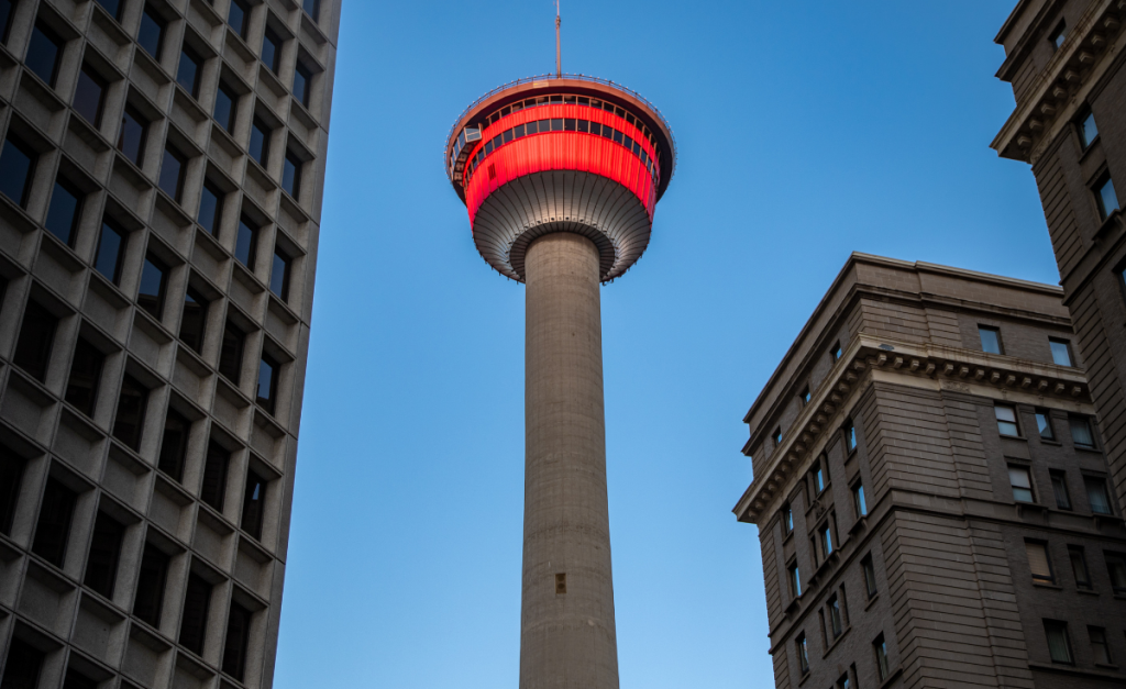 a large tv tower with a red top stands in Calgary