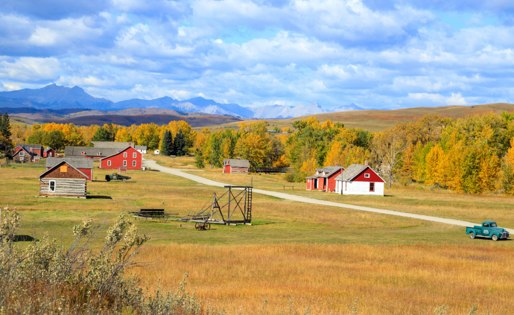 Bar U Ranch in Alberta a collection of small farm houses, a vintage truck, autumn colors and mountains 