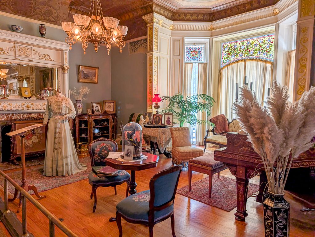 An opulent sitting room decorated in a Victorian-style at a museum.
