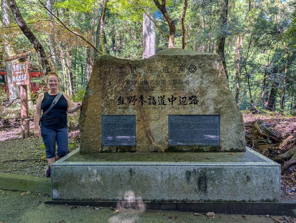 Sooz standing in front of the Kumano Kodo UNESCO monument at Hosshinmon-oji