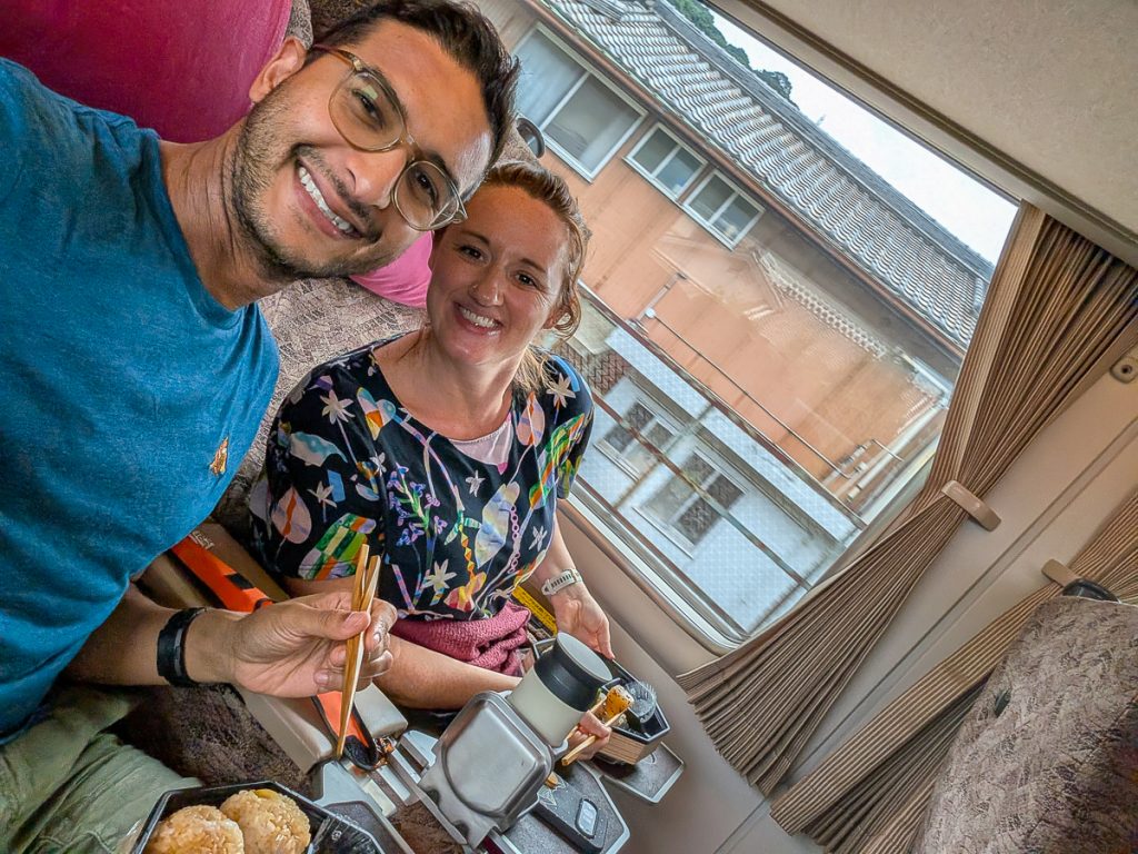 Susanna and Ganesh sitting on a Japanese train