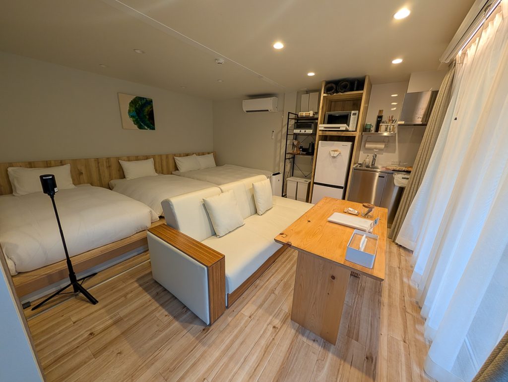 Accommodation along the Kumano Kodo a room with three beds, living room and kitchenette 