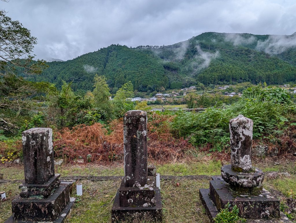 Ancient Japanese burial site with stone graves overlooking the mountain