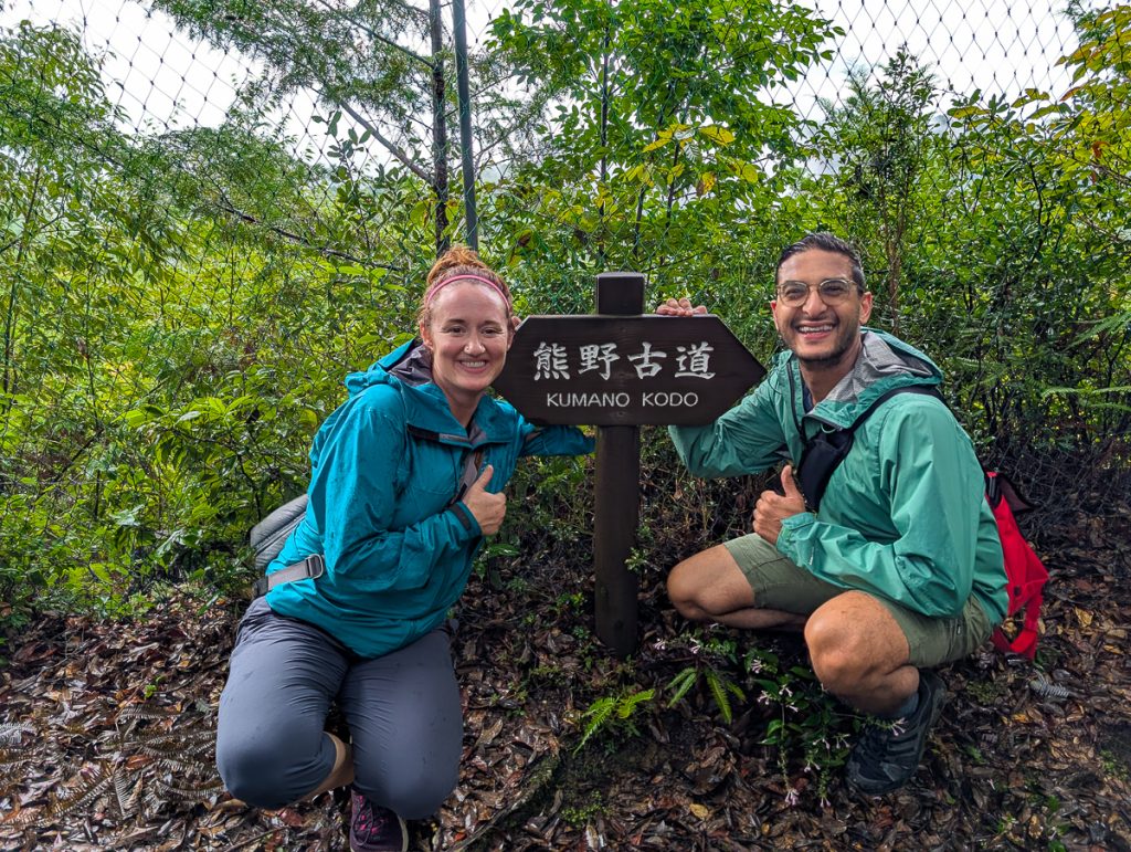 Ganesh and Susanna pose next to the Kumano Kodo trail sign on their hike