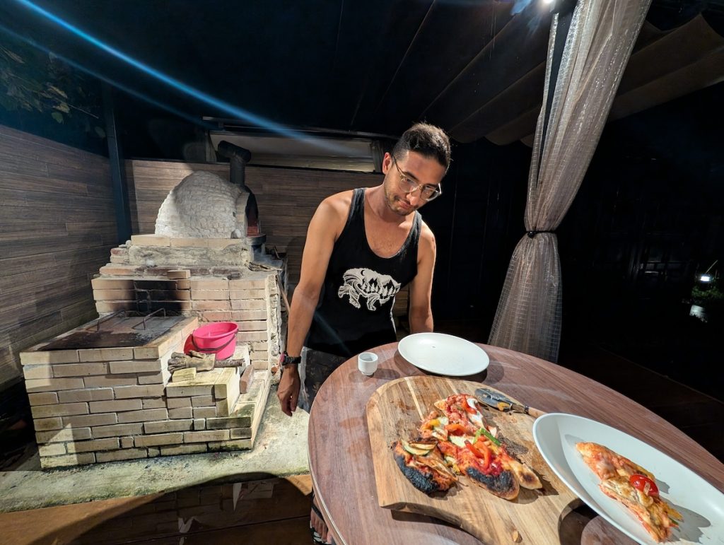 Ganesh looks sad trying to make pizza while on the Kumano Kodo in Japan
