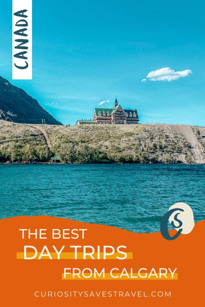 A photo of a hotel on an outcropping of land with a bright blue sky above and bright blue water in front, with an orange text box below the image which says "The best day trips from Calgary."