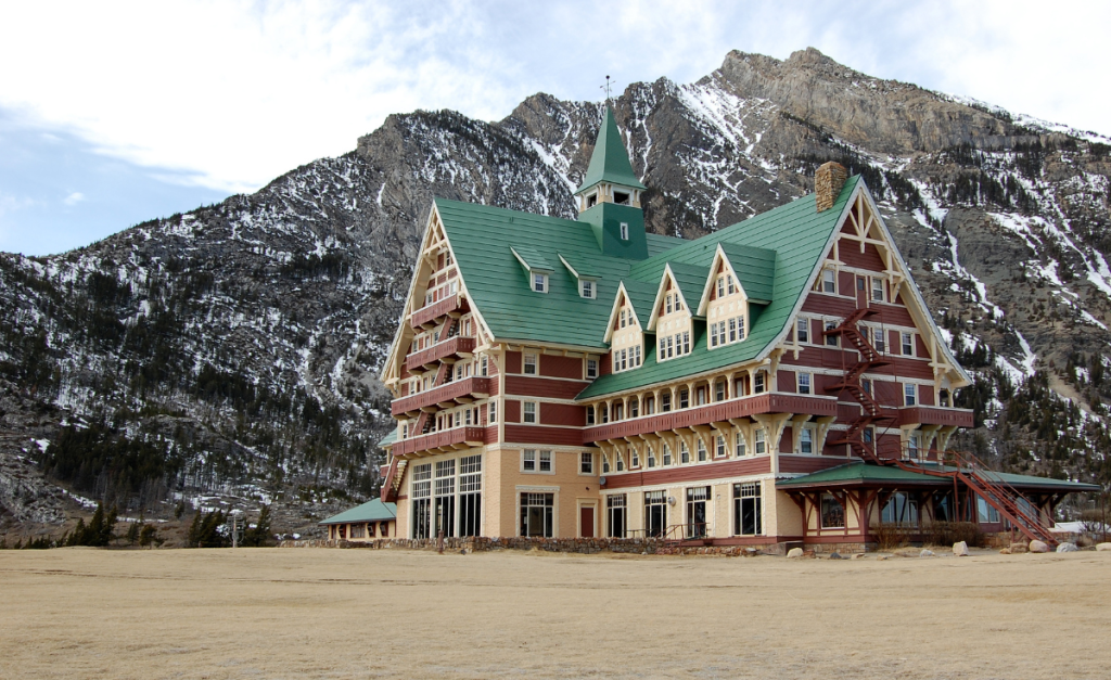 Prince of Wales heritage hotel in front of a rocky mountain