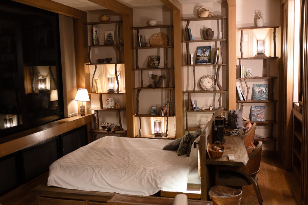 A wooden bed and shelves in a luxury wooden home