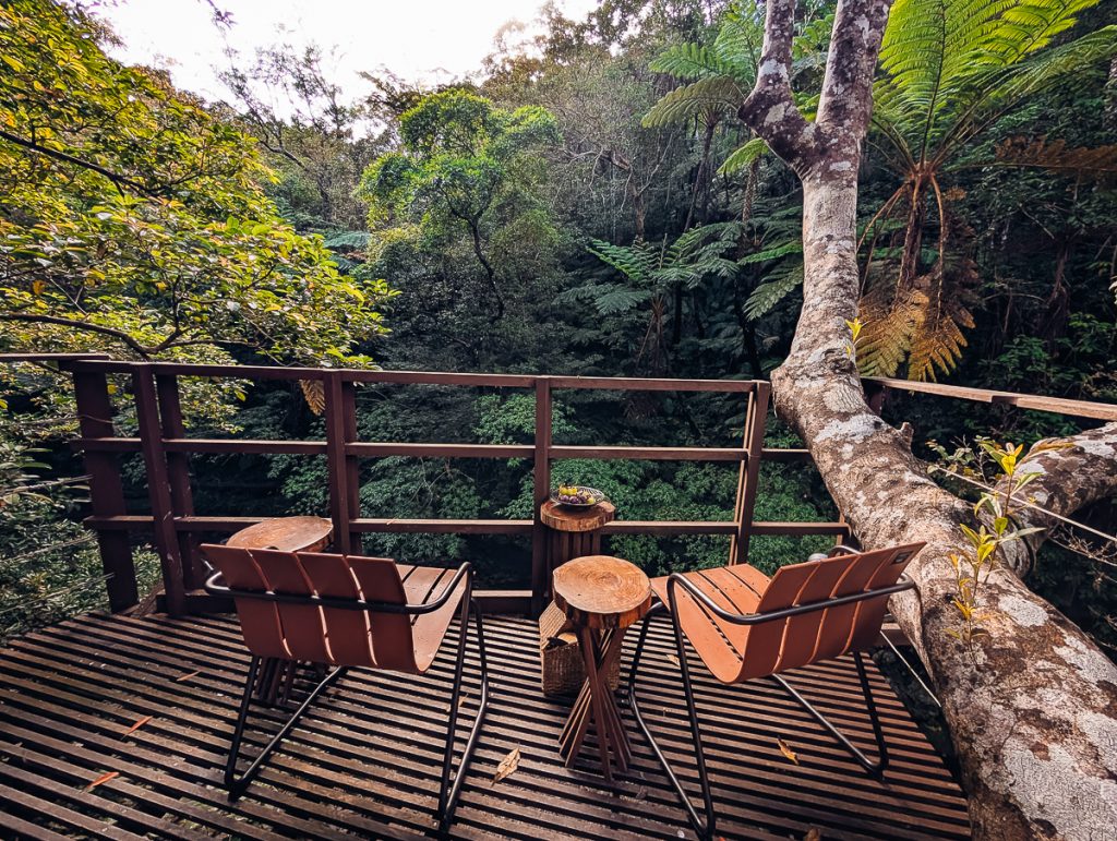 wooden chairs and a table on a deck