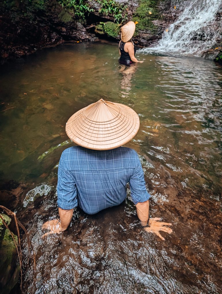 Ganesh and Susanna get into a waterfall pool