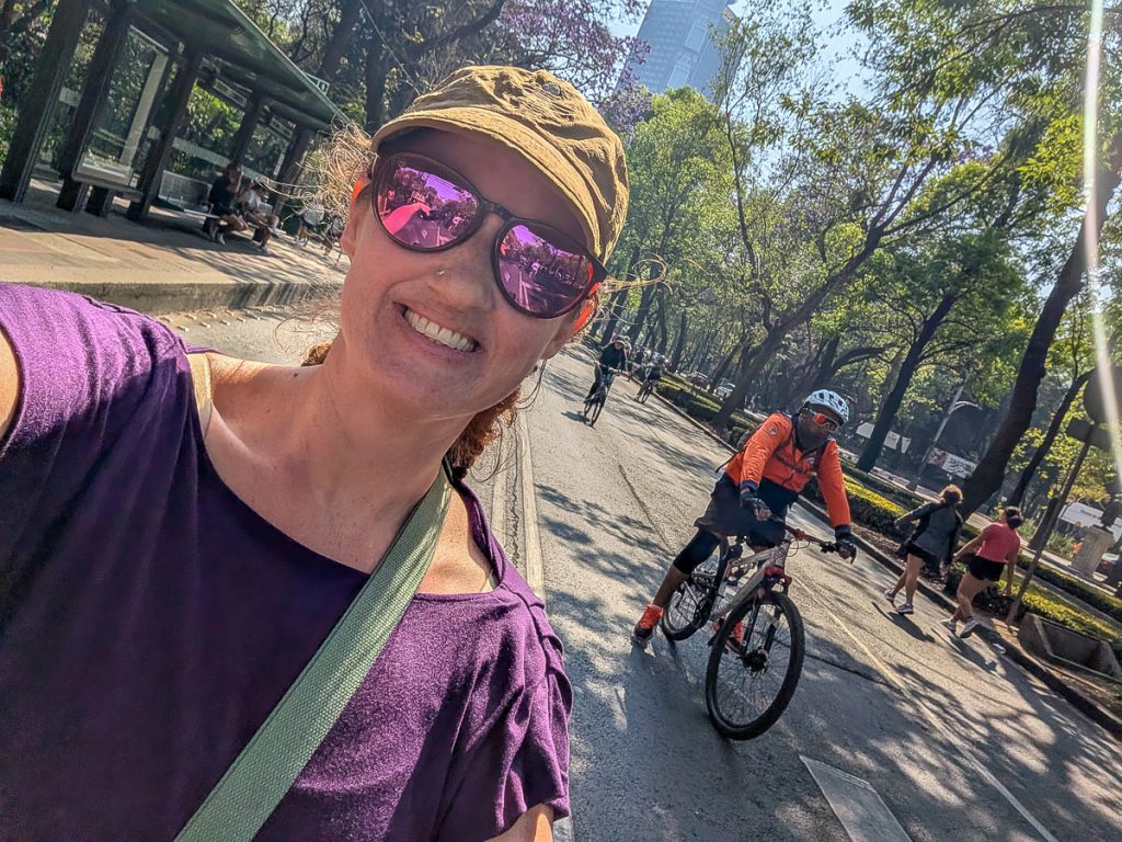 Sooz smiles taking a selfie on a bike