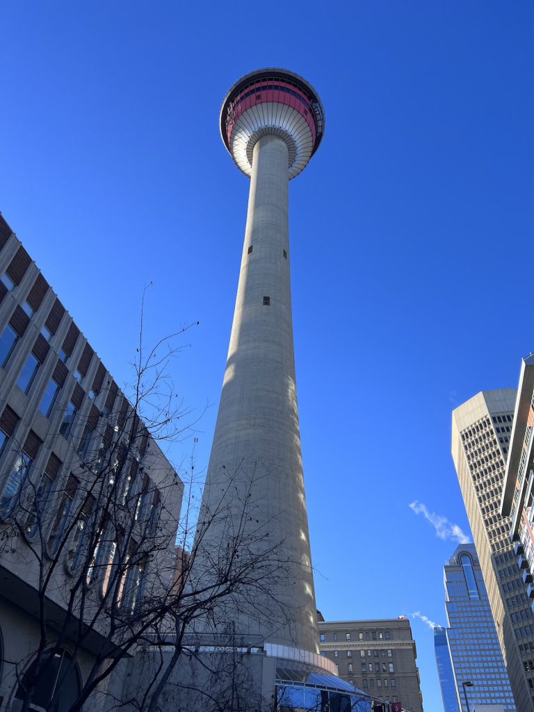 View from the base of a very tall tower with a completely blue sky behind.