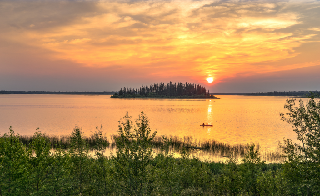 A canoe out on Lake Astotin at sunset in Elk Island National Park