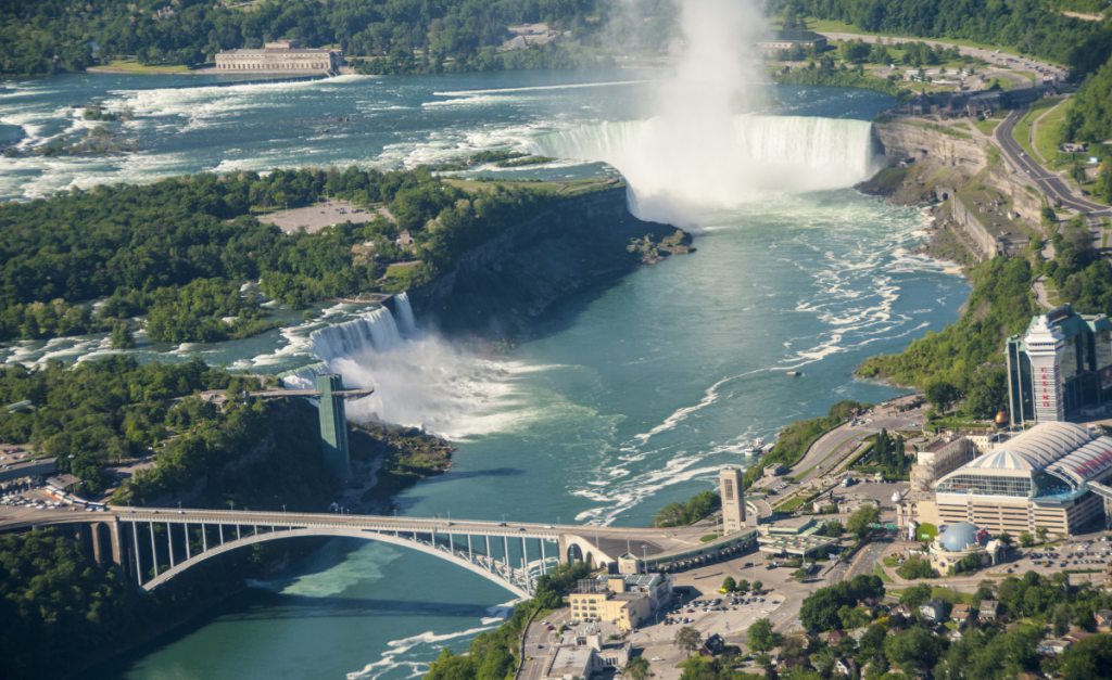 An overhead photo of the Niagara River from the Canadian side, with a view of all three falls.