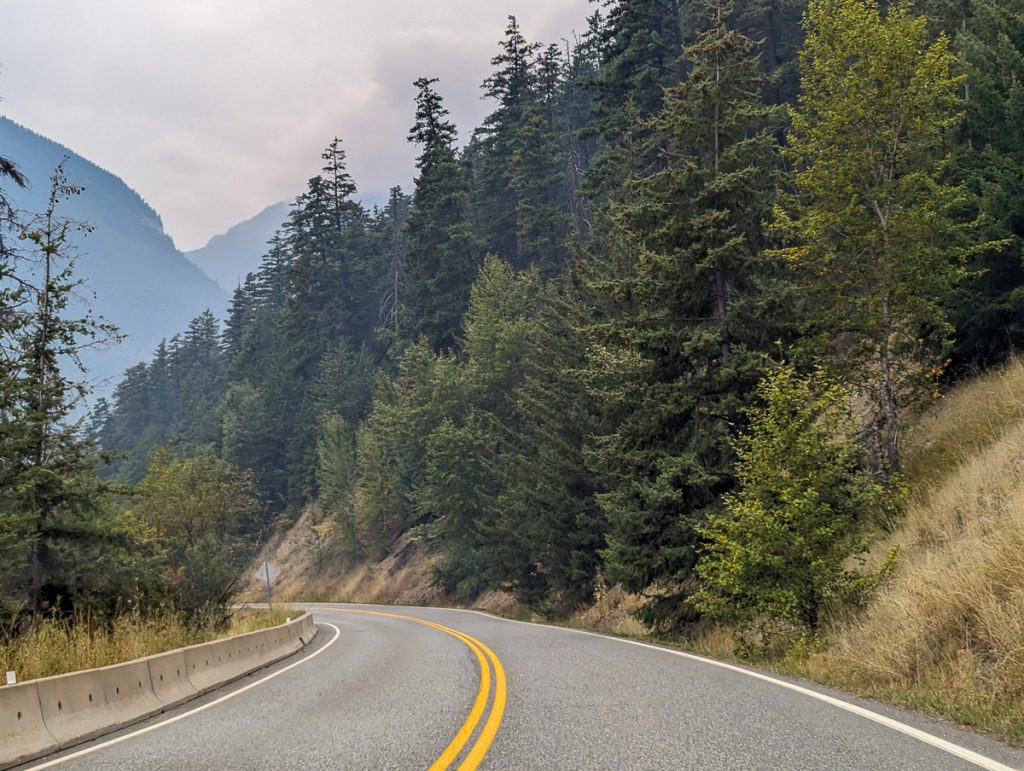 a road winding down through a mountain