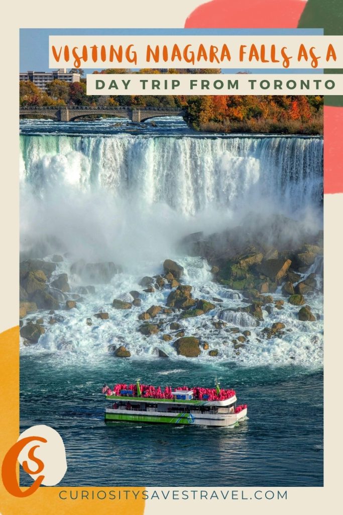 A photo of a boat cruising at the base of a waterfall with text at the top of the image that says "Visiting Niagara Falls as a day trip from Toronto."