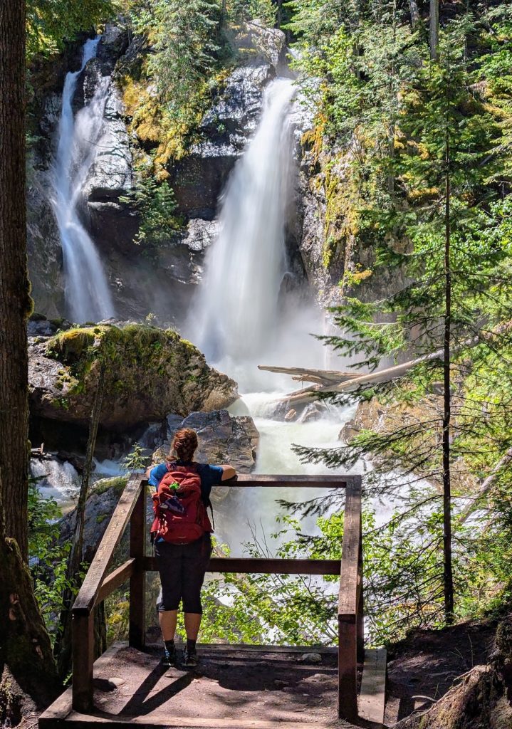 A woman in front of Begbie Waterfall in Revelstoke