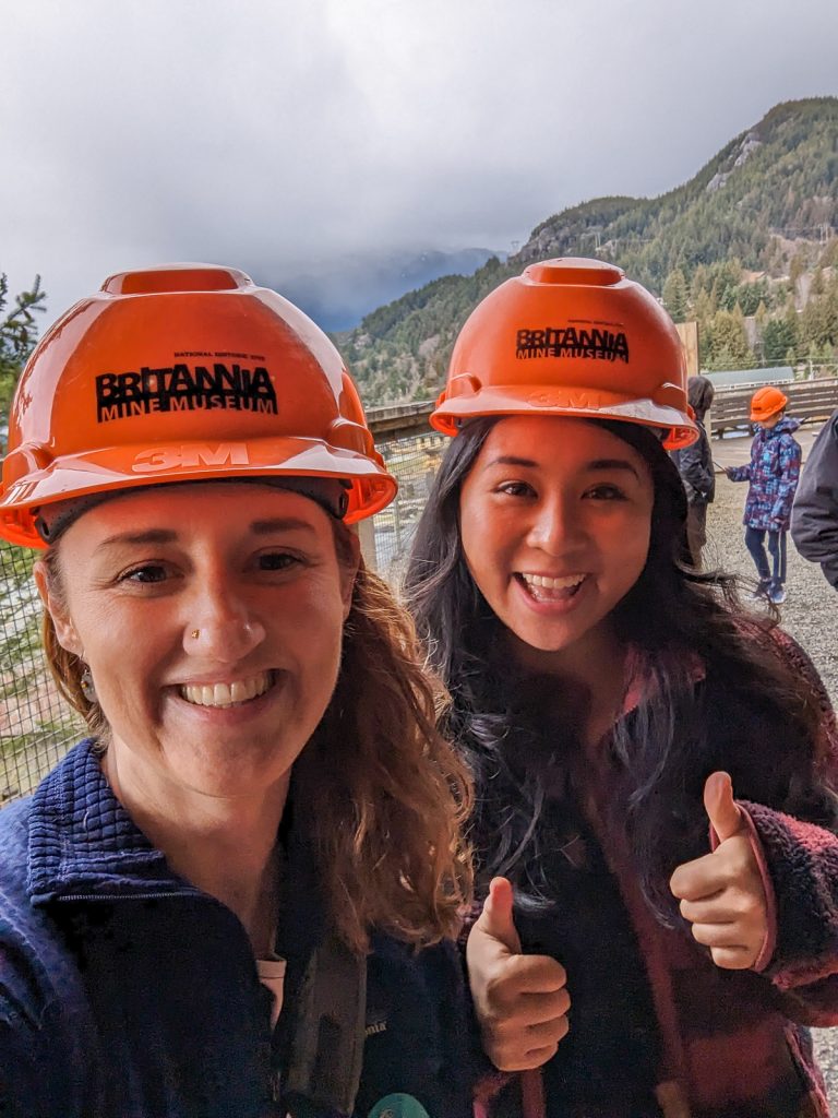 Two women wear hard hats on the Britannia Mine Tour