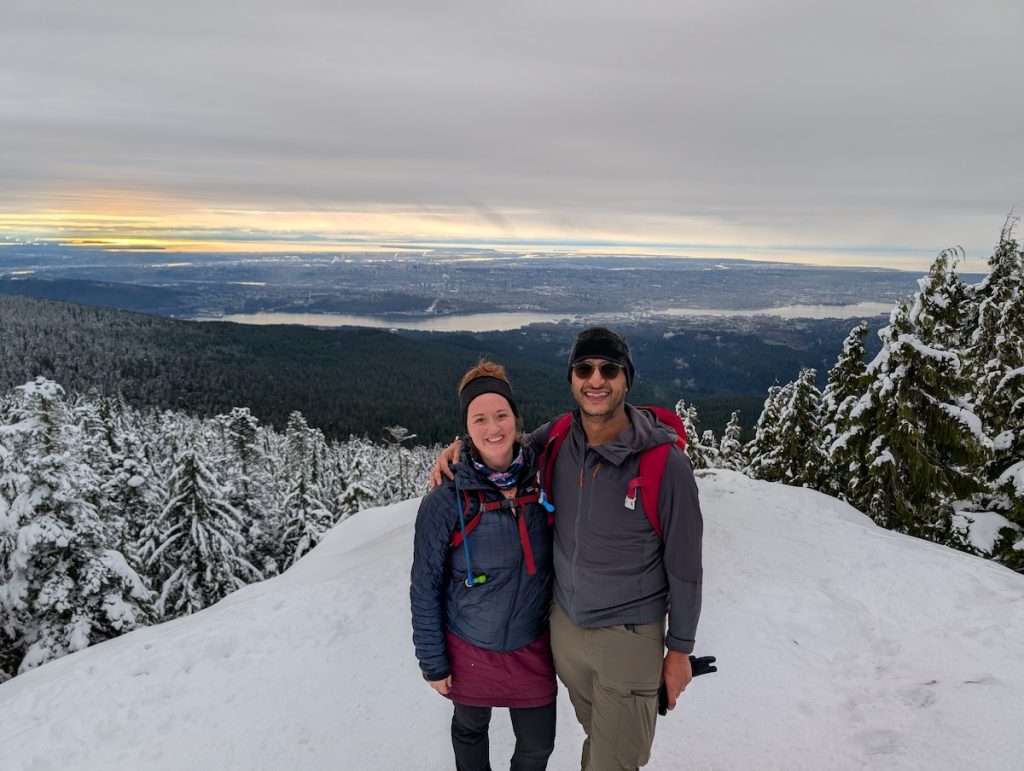 A man and women hiking in winter wearing winter clothing layers
