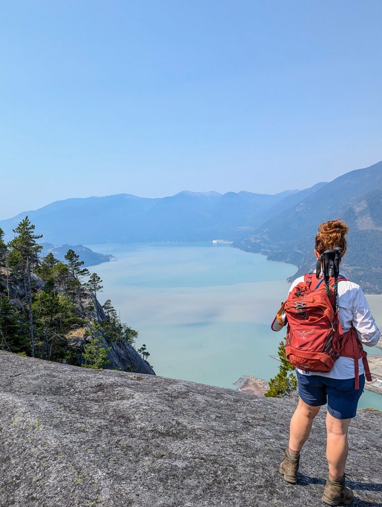 a woman on top of a rocky mountain