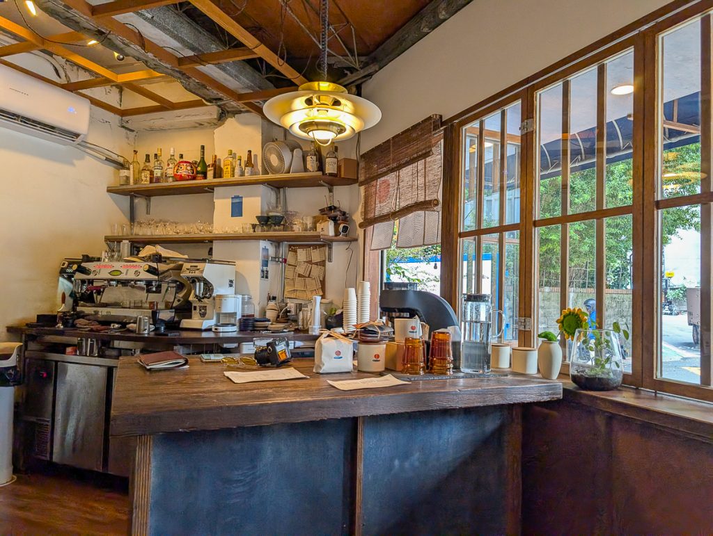 A small, wooden coffee bar inside a rustic building.
