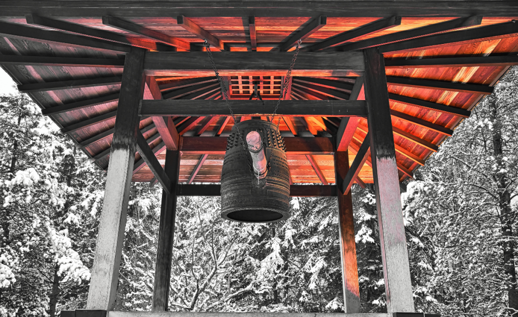 A Japanese pagoda surrounded by trees covered in snow.