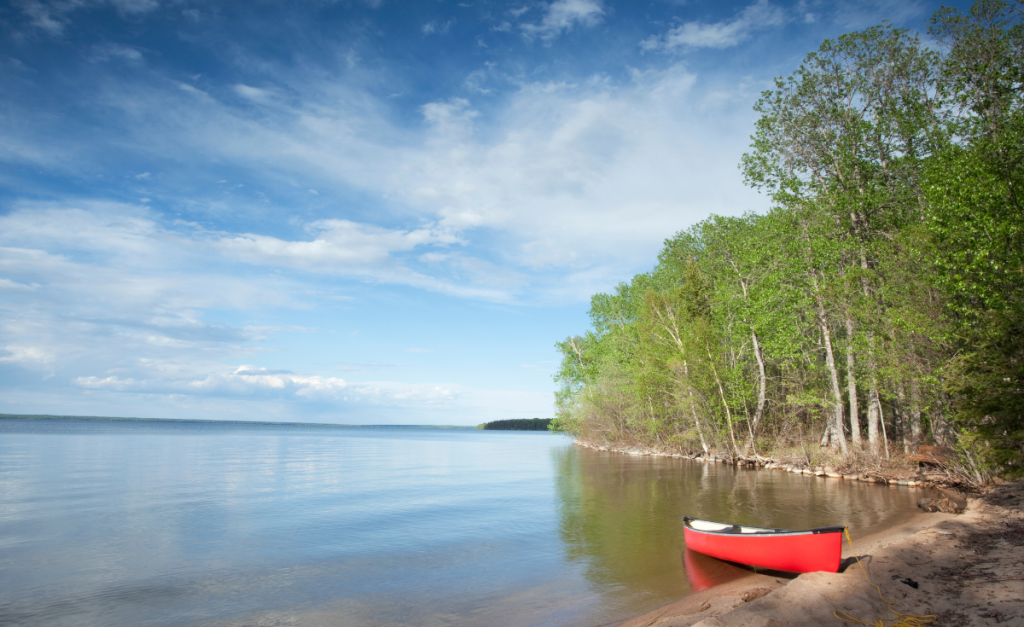 a red canoe on the lake in Prince Albert National Park