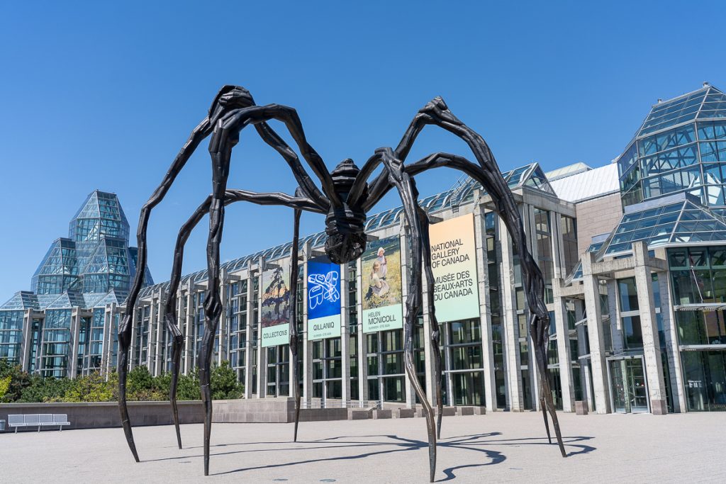 An abstract statue of a spider in front of Ottawa's art gallery