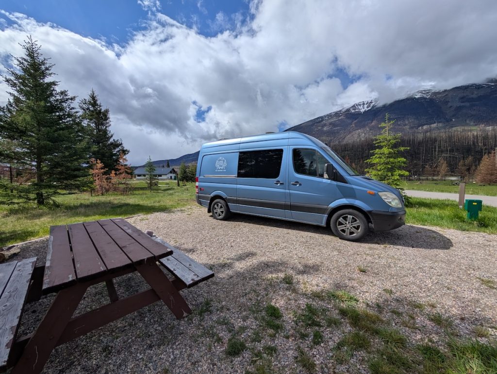 A blue campervan at a campsite called Whistlers in Jasper National Park 